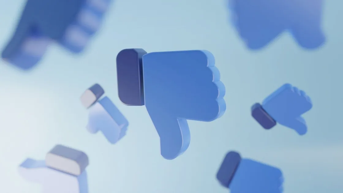 Multiple blue thumbs-down icons floating against a light blue background, suggesting disapproval and backlash.